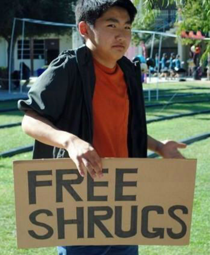 man shrugs holding 'free shrugs' sign